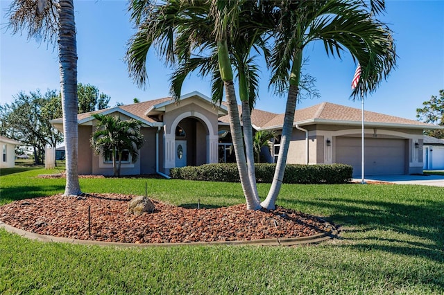 ranch-style house featuring a front yard and a garage