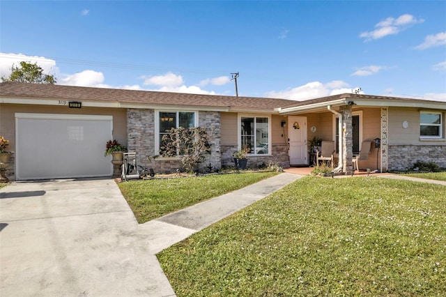 ranch-style house with a garage and a front lawn