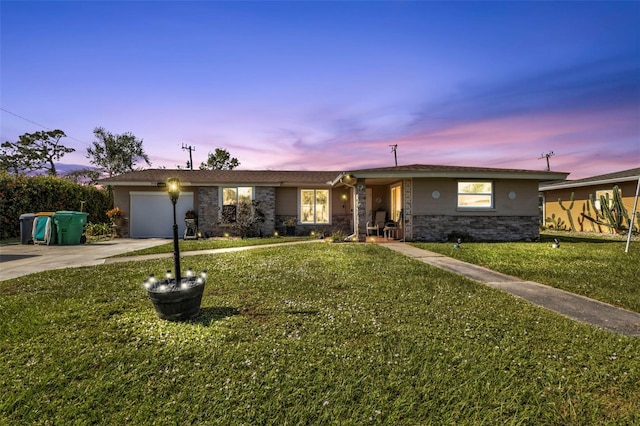 single story home featuring a yard and a garage