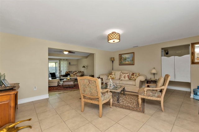 living room featuring ceiling fan and light tile patterned flooring