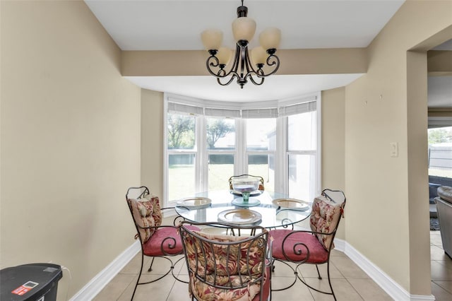 dining area with a notable chandelier and light tile patterned flooring