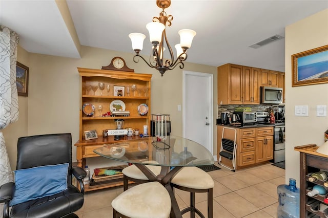 tiled dining area with a notable chandelier