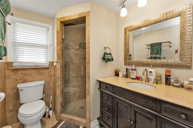 bathroom featuring vanity, tile walls, tile patterned flooring, toilet, and a shower with shower door