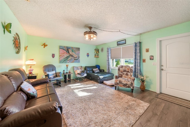 living room featuring a textured ceiling and dark wood-type flooring