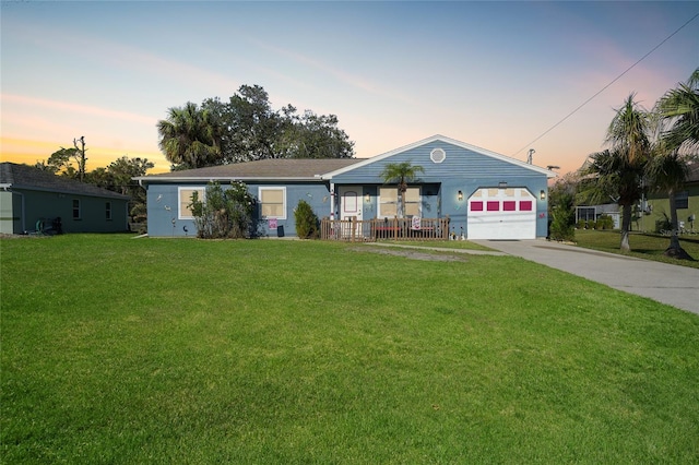 ranch-style home with a yard and a garage