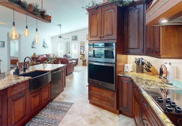 kitchen featuring sink, vaulted ceiling, ceiling fan, appliances with stainless steel finishes, and light stone counters