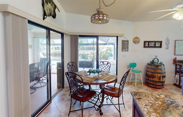 dining room with light tile patterned floors and ceiling fan