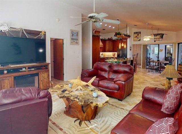 living room featuring ceiling fan and high vaulted ceiling