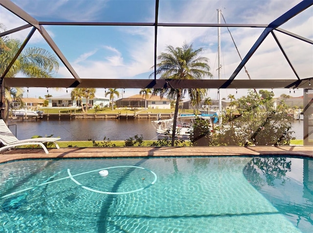 view of pool with a lanai and a water view