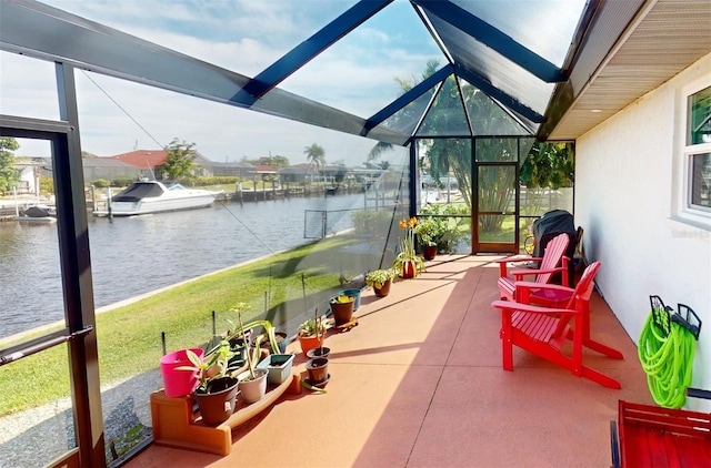 sunroom with a water view and lofted ceiling