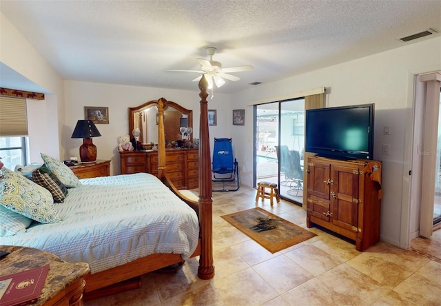 bedroom featuring a textured ceiling, access to exterior, ceiling fan, and multiple windows