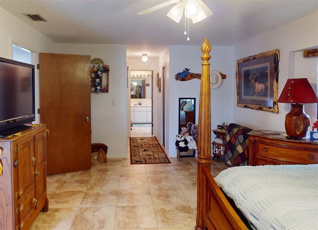 bedroom featuring ceiling fan, light tile patterned flooring, and ensuite bathroom