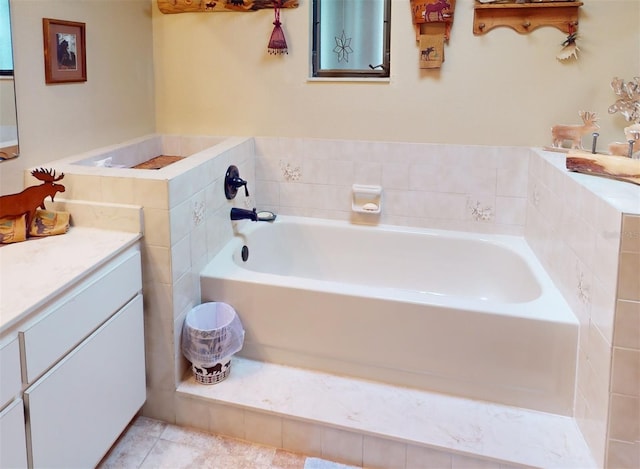 bathroom featuring a washtub, vanity, and tile patterned floors