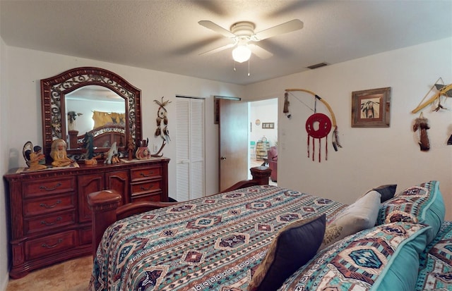 bedroom featuring ceiling fan, a closet, and a textured ceiling