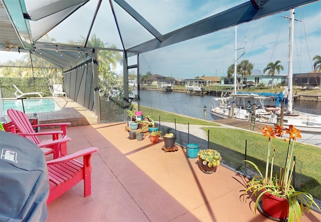 view of patio / terrace featuring glass enclosure and a water view