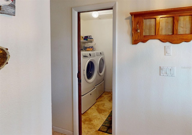 washroom featuring washing machine and dryer and light tile patterned floors