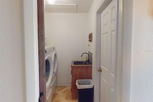 laundry area featuring sink, light tile patterned floors, and independent washer and dryer