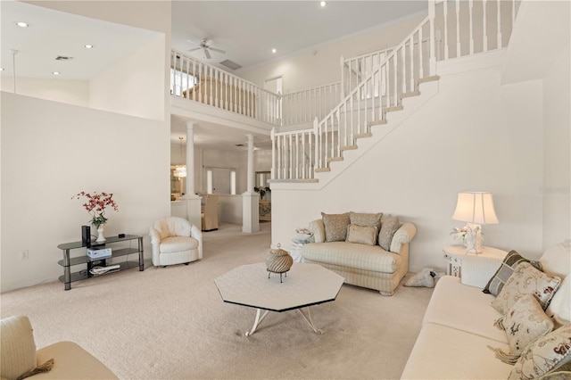 3800 Bal Harbor Blvd Unit 312, Punta Gorda, FL 33950 - carpeted living room with a high ceiling, a ceiling fan, decorative columns, stairway, and recessed lighting