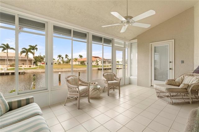 sunroom / solarium with a water view, vaulted ceiling, a wealth of natural light, and ceiling fan