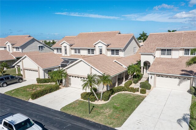 3800 Bal Harbor Blvd Unit 312, Punta Gorda, FL 33950 - view of front of house featuring a tile roof, driveway, a residential view, and stucco siding