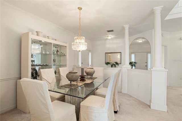 3800 Bal Harbor Blvd Unit 312, Punta Gorda, FL 33950 - dining room featuring light carpet, crown molding, a chandelier, and arched walkways