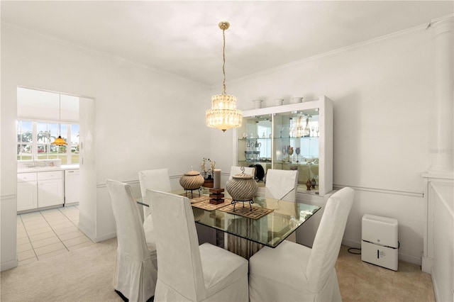 carpeted dining room featuring an inviting chandelier and ornamental molding