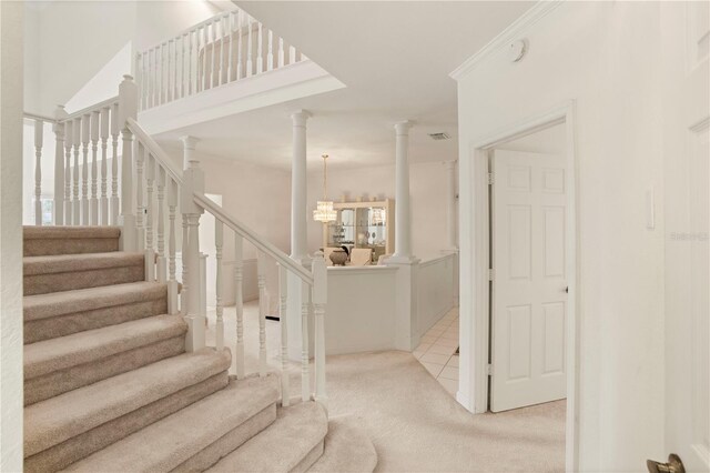 3800 Bal Harbor Blvd Unit 312, Punta Gorda, FL 33950 - stairs with ornate columns, carpet floors, and a chandelier