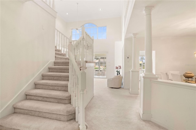 3800 Bal Harbor Blvd Unit 312, Punta Gorda, FL 33950 - stairway with carpet, ornate columns, baseboards, and a towering ceiling