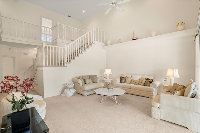 3800 Bal Harbor Blvd Unit 312, Punta Gorda, FL 33950 - carpeted living room with a high ceiling, stairs, a ceiling fan, ornamental molding, and baseboards