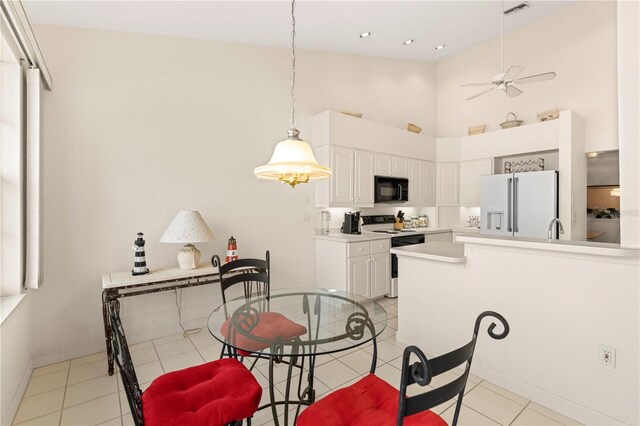 3800 Bal Harbor Blvd Unit 312, Punta Gorda, FL 33950 - dining space with high vaulted ceiling, light tile patterned floors, baseboards, and ceiling fan