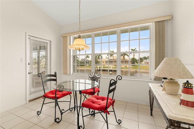 3800 Bal Harbor Blvd Unit 312, Punta Gorda, FL 33950 - dining area featuring plenty of natural light, baseboards, light tile patterned floors, and a water view