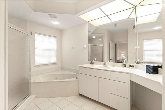 bathroom featuring tile patterned flooring, shower with separate bathtub, vanity, and a wealth of natural light