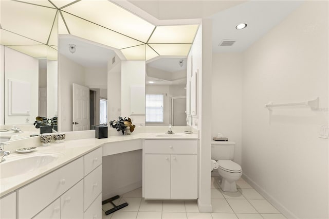 bathroom featuring tile patterned floors, vanity, toilet, and an enclosed shower