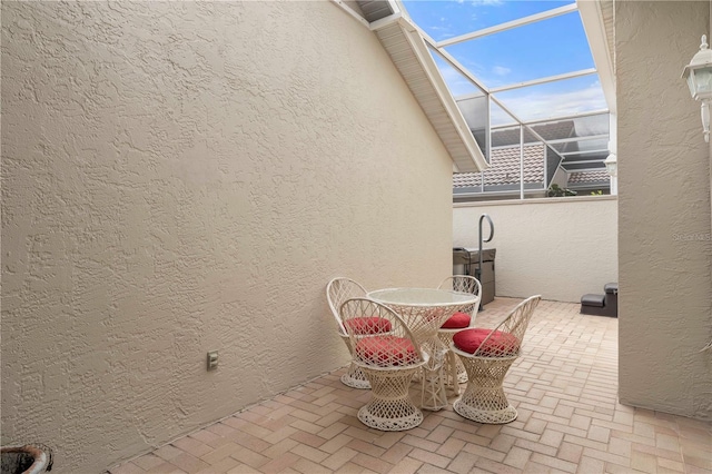 view of patio / terrace featuring a lanai