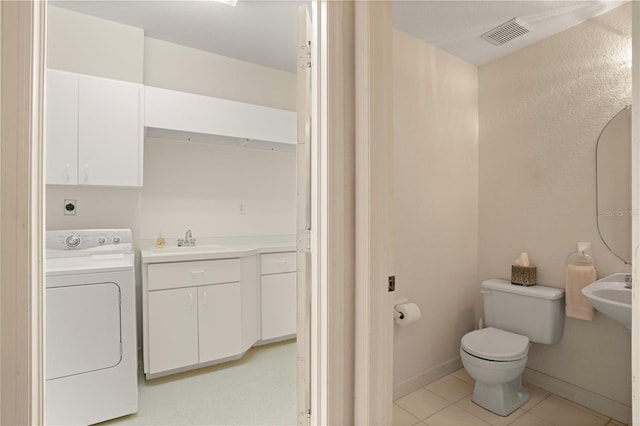 3800 Bal Harbor Blvd Unit 312, Punta Gorda, FL 33950 - bathroom featuring washer / dryer, a sink, toilet, tile patterned flooring, and baseboards