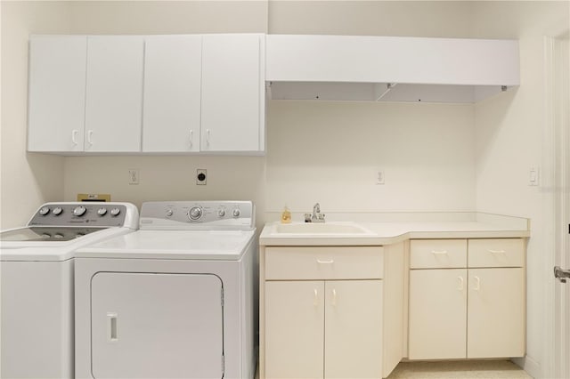 laundry room with washer and dryer, sink, and cabinets