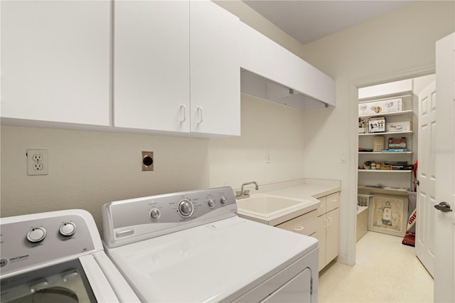 clothes washing area with cabinets, separate washer and dryer, and sink