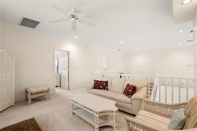 living room featuring ceiling fan, light colored carpet, and crown molding