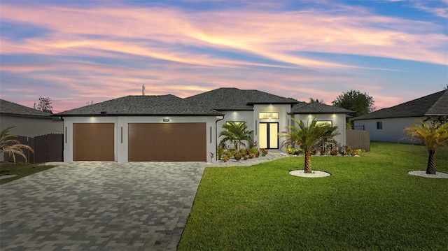 view of front of house with a lawn and a garage