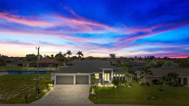 view of front of house with a lawn and a garage