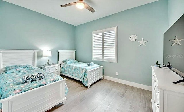 bedroom with light hardwood / wood-style flooring and ceiling fan