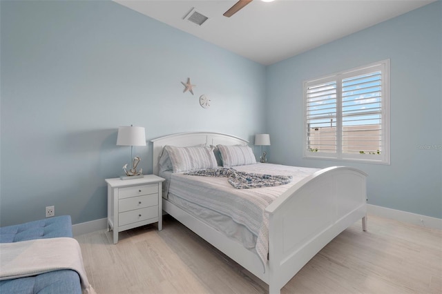 bedroom with light hardwood / wood-style flooring and ceiling fan