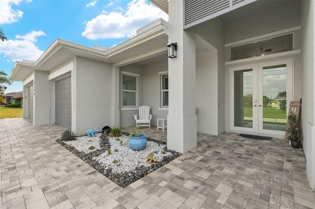 view of patio / terrace featuring a garage and french doors