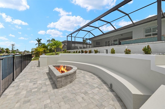 view of patio / terrace featuring a lanai and a fire pit