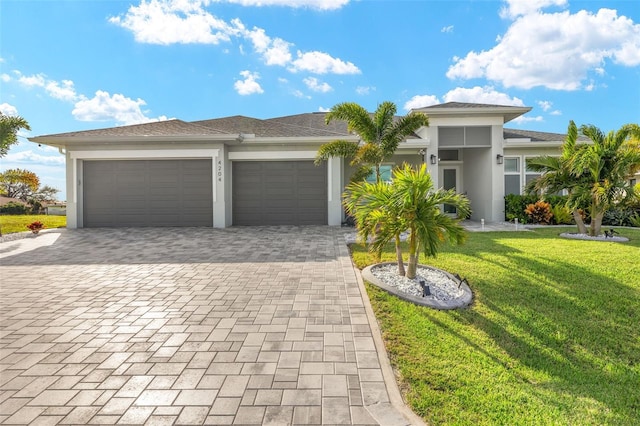 view of front of property featuring a garage and a front yard