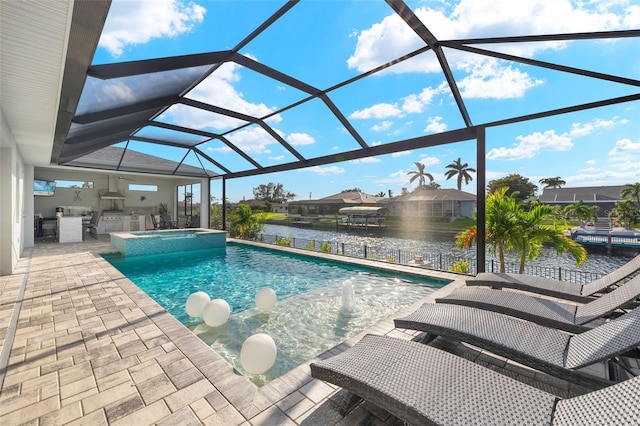 view of pool featuring an in ground hot tub, a lanai, exterior kitchen, a water view, and a patio area