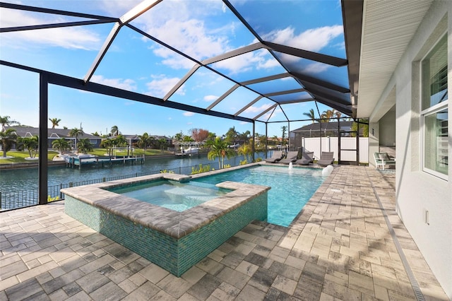 view of swimming pool with an in ground hot tub, a patio, a water view, and a lanai