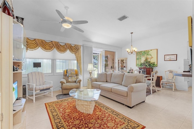 living room featuring lofted ceiling, plenty of natural light, light tile patterned floors, and ceiling fan with notable chandelier