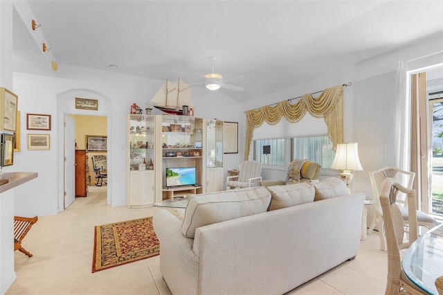 tiled living room with ceiling fan, lofted ceiling, and a wealth of natural light