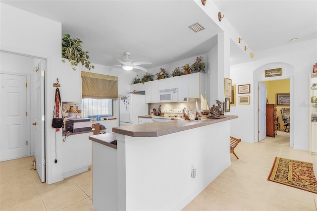 kitchen with white cabinetry, white appliances, and kitchen peninsula